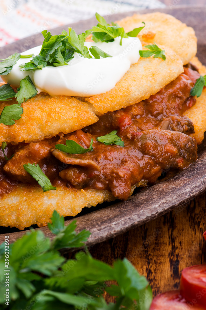 Potato pancakes with meat, vegetable, tomato and parsley Potato pancakes with meat, vegetable, tomato and parsley