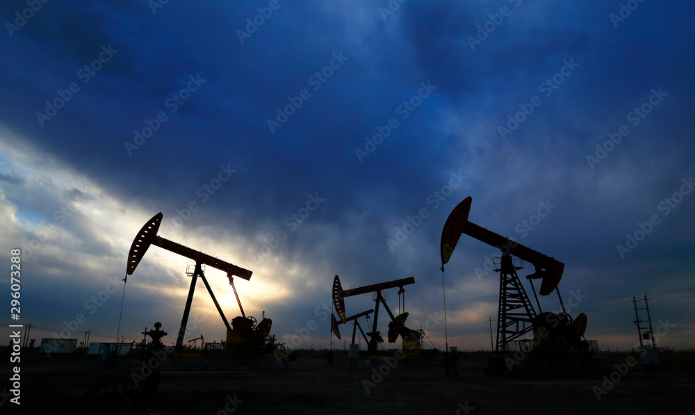 Is operation of pumping unit, sunset in oil field Is operation of pumping unit, sunset in oil field