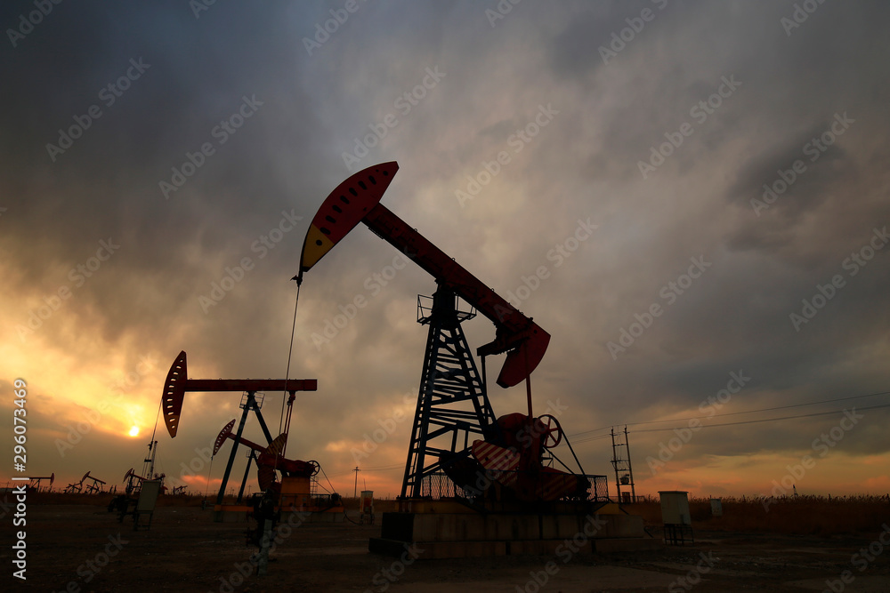 Is operation of pumping unit, sunset in oil field Is operation of pumping unit, sunset in oil field