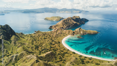 Aerial panoramic view of Padar island in Komodo National Park, Indonesia. Drone shot, top view. Green hills and amazing beautiful coastline. Tropical background.
