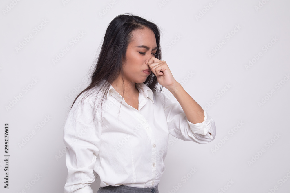 Young Asian woman holding her nose because of a bad smell. Young Asian woman holding her nose because of a bad smell.