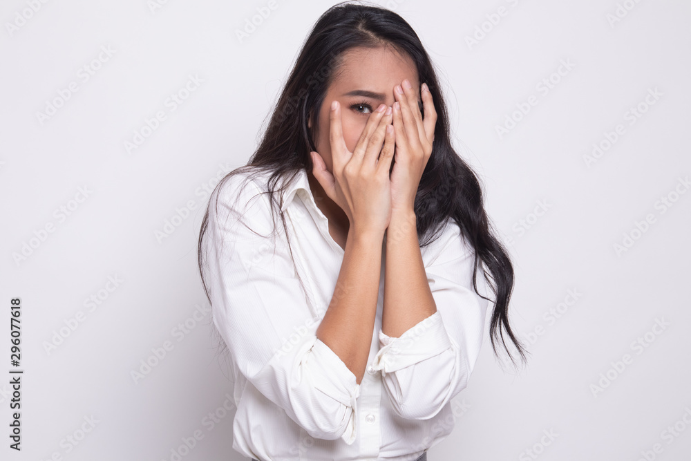 Beautiful young Asian woman peeking through fingers. Beautiful young Asian woman peeking through fingers.