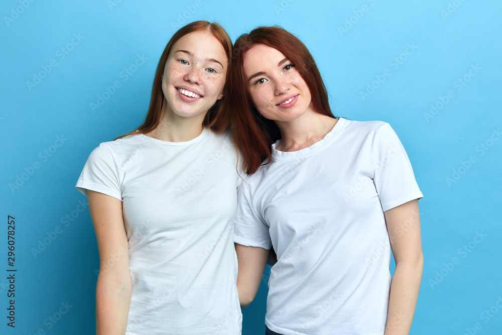 smiling beautiful pleasant women embracing each other, close up portrait, studio shot.free time, spare time . smiling beautiful pleasant women embracing each other, close up portrait, studio shot.free time, spare time .