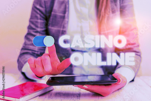 Conceptual hand writing showing Casino Online. Concept meaning Computer Poker Game Gamble Royal Bet Lotto High Stakes Business concept with communication mobile phone photo