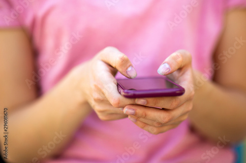 young female hands holding cellphone