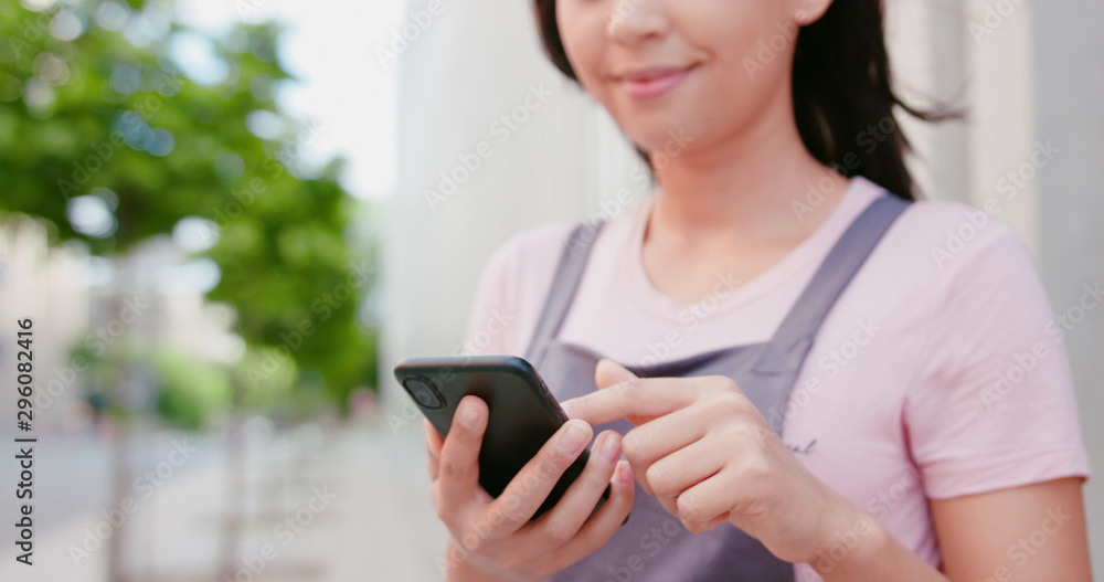 A young beautiful lady using a phone outdoors. A young beautiful lady using a phone outdoors.