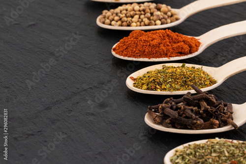 Various spices on dark background, with copy space