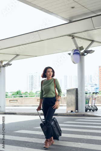 Young lovely asian woman is traveling with luggage in airport