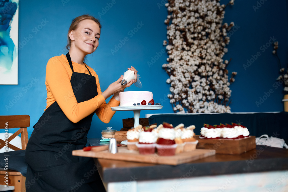 smiling blonde girl enjoying decorating dessert for a party. close up photo. favourite job, hobby, interest, close up photo smiling blonde girl enjoying decorating dessert for a party. close up photo. favourite job, hobby, interest, close up photo