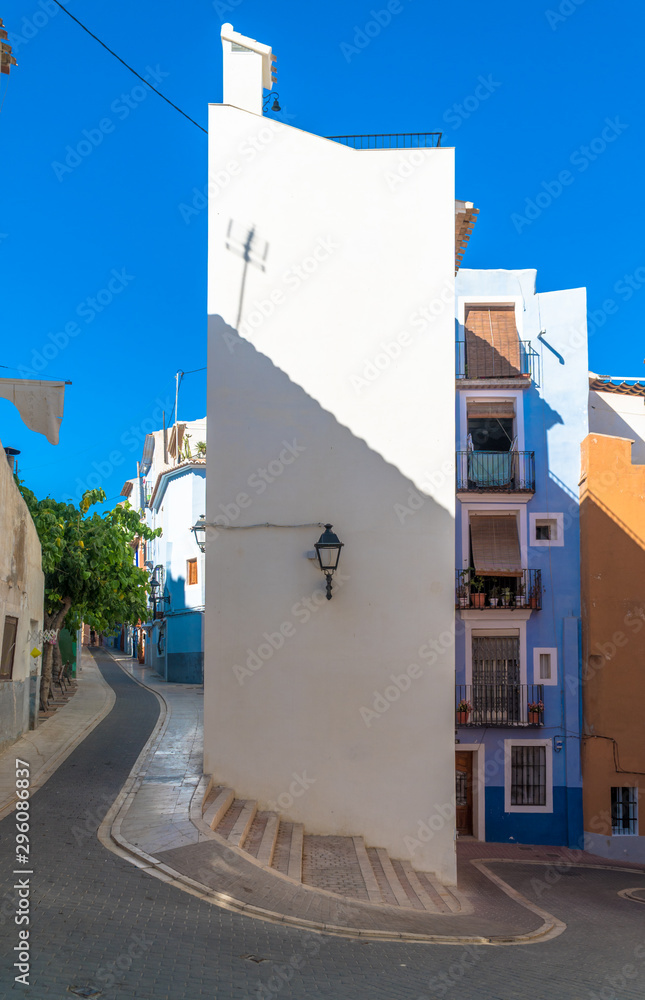La Vila Joiosa, Comunitat Valenciana / Spain - July 29th, 2019: Narrow and curvy street in the town center