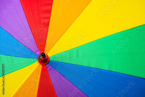 Details of a rainbow coloured umbrella.