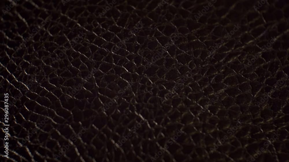 surface smooth polished textured shiny dark leather.close-up.abstract moving background surface smooth polished textured shiny dark leather.close-up.abstract moving background