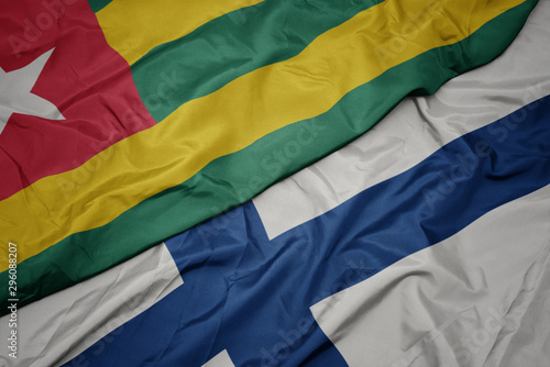 waving colorful flag of finland and national flag of togo.