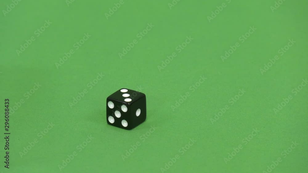 Green screen shot of a black dice rolling 3 Green screen shot of a black dice rolling 3