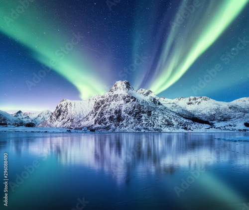 Aurora Borealis, Lofoten islands, Norway. Nothen light and reflection on the lake surface. Winter landscape at the night time. Norway travel - image photo