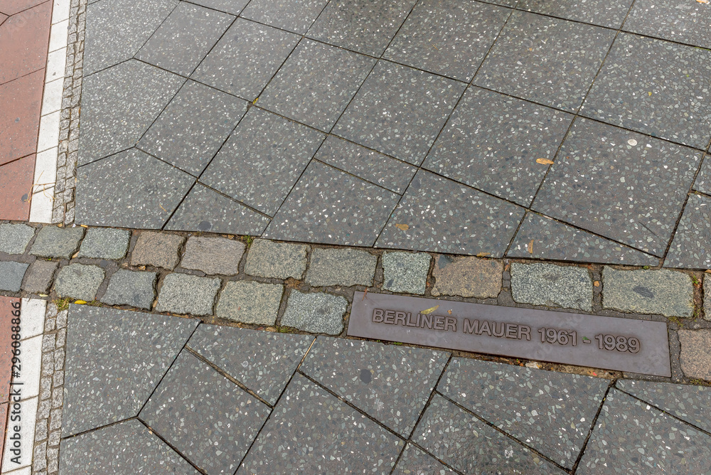 Fototapeta premium Plaque in the floor of Potsdamer Platz indicates the point where the famous Berlin Wall, Germany, passed
