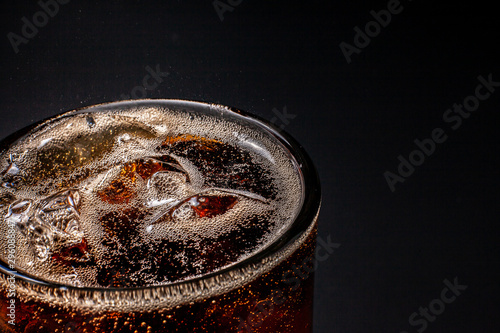 Fizz sparkling Cola water Refreshing bubbly Soda Pop with Ice Cubes. Cold soft drink cola carbonated liquid fresh and cool iced drink in a glasses . Refreshing and quench thirst concept .
