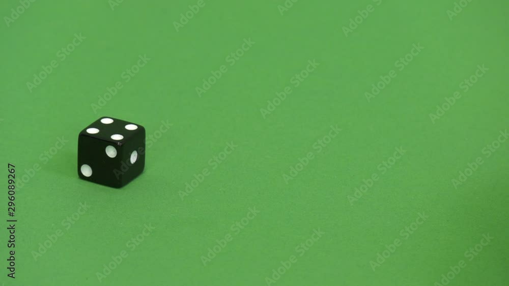 Green screen shot of a black dice rolling 4 Green screen shot of a black dice rolling 4