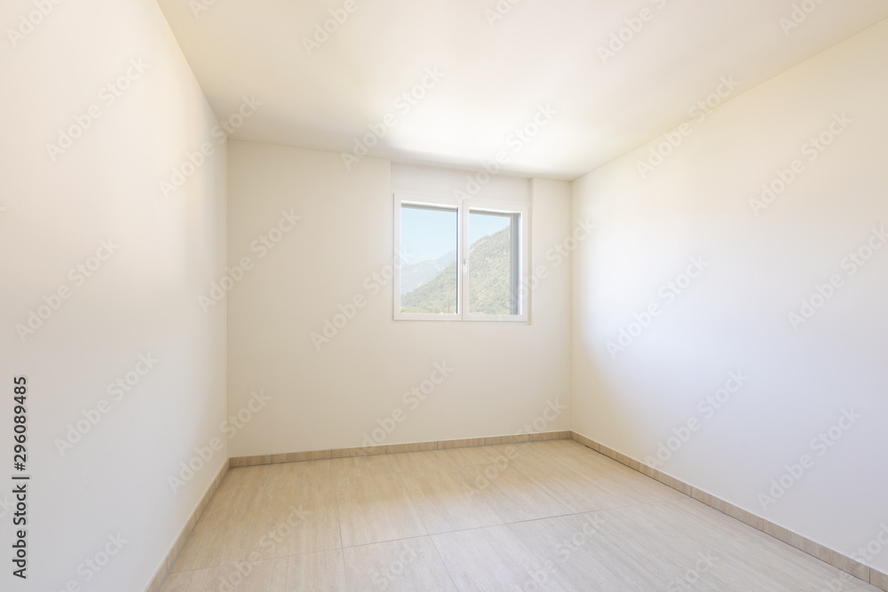 Empty room with white walls and traverti floors. Empty room with white walls and traverti floors.