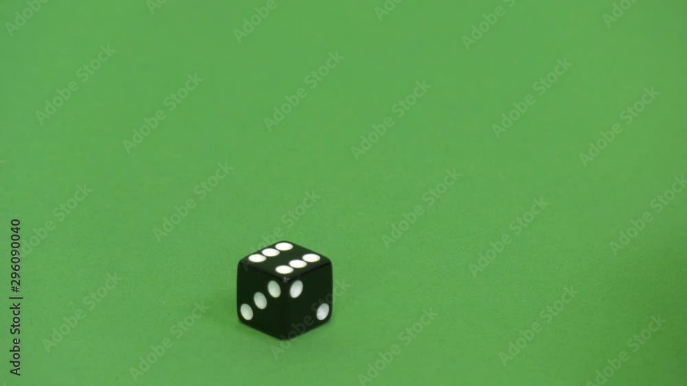 Green screen shot of a black dice rolling 6 Green screen shot of a black dice rolling 6