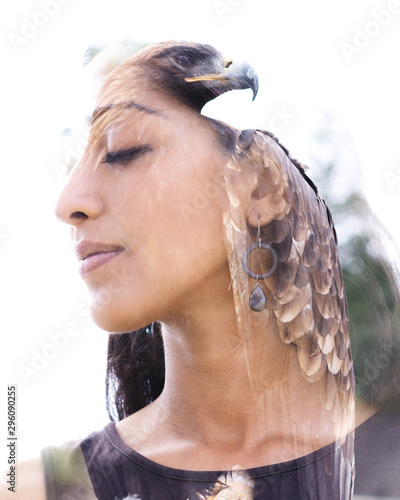 Double exposure portrait of a beautiful young woman combined with a close up photograph of an exotic eagle