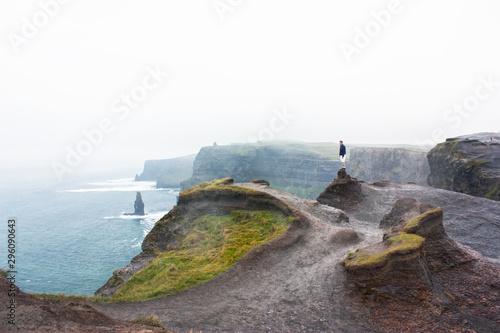 man looking out over cliffs © Jessie