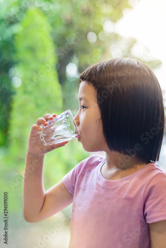 Little asian girl drinking water. Water is very useful and important to the health of the body.