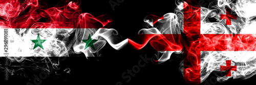 Syria vs Georgia, Georgian smoke flags placed side by side. Thick colored silky smoke flags of Syrian and Georgia, Georgian photo