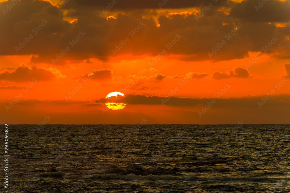 Beautiful sunset and golden twilight, and clouds over the Mediterranean Sea in Tel Aviv, Israel