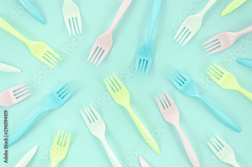Colorful forks composition on turquoise background