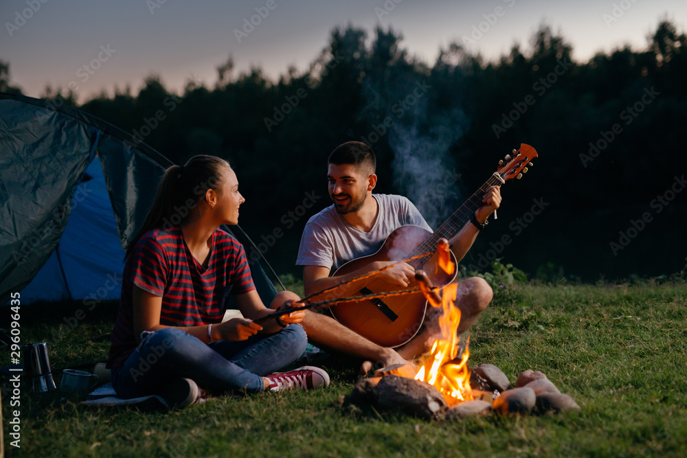 campers outdoor camping by the river barbecuing