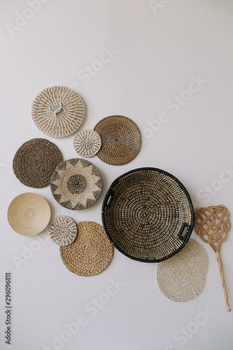 Boho style, minimal home interior design. Decorative straw plates on the wall. Exotic interior.