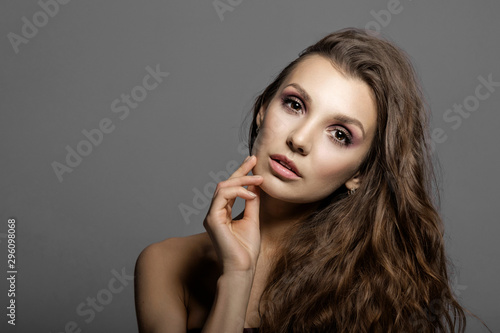 beauty portrait of attractive young woman, beautiful lips and makeup. natural beauty, facial care, clean skin, gray background