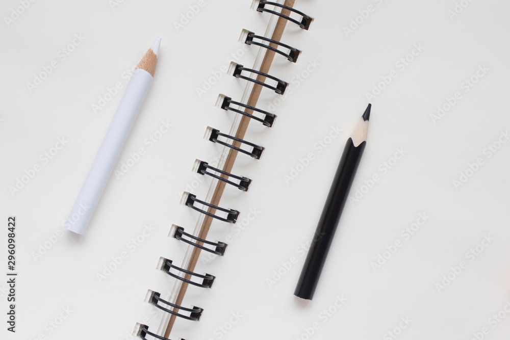 white and black pencil on Notepad, business concept, top view, copy space white and black pencil on Notepad, business concept, top view, copy space