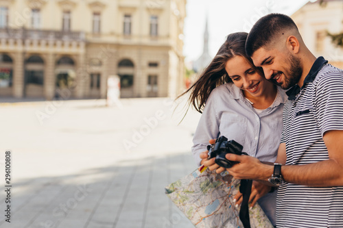 couple tourist in sightseeing in city using photo camera photo