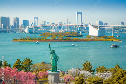 Cherry blossoms bloom in Odaiba.View of Tokyo Bay. Beautiful replica of the Statue of Liberty in Odaiba Bay from Japan.View of Odaiba in Japan. photo