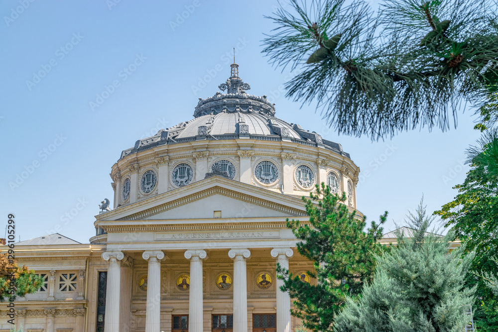 Romanian Athenaeum, a concert hall in the center of Bucharest, Romania and a landmark of the Romanian capital city. Romanian Athenaeum a sunny summer day with blue sky in Bucharest, Romania