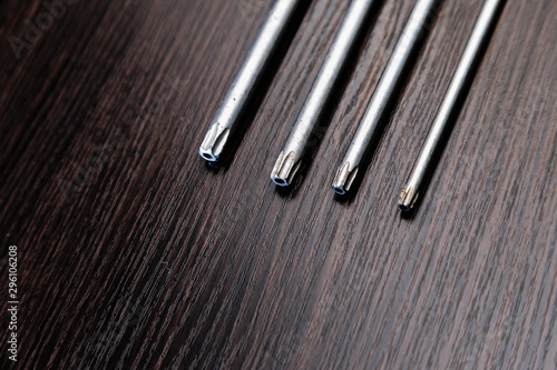 Torx.Wrenches on a dark wooden background. Close-up.