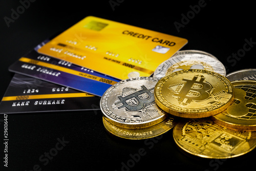 physical version of bitcoin and leather wallet and credit card that is a new virtual money world cryptocurrency and digital payment system by using blockchain technology on black background