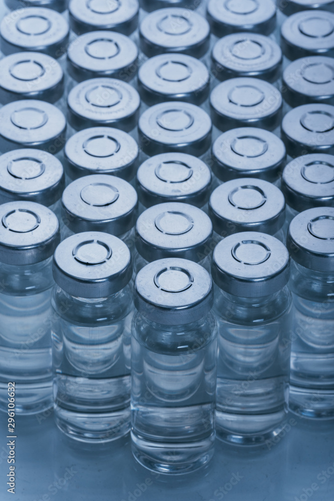 Glass medical ampoule vial for injection. Medicine is dry white drug penicillin powder or liquid with of aqueous solution in ampulla. Close up. Glass medical ampoule vial for injection. Medicine is dry white drug penicillin powder or liquid with of aqueous solution in ampulla. Close up.