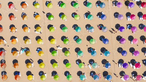Aerial view to a sandy beach and sunshade with sunumbrellas photo