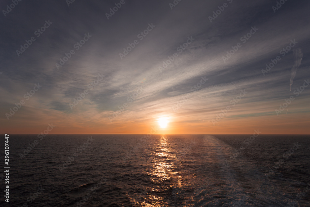 Reflection of dreamy sunset over the sea and wake left by a cruise ship, Adriatic sea, Italy Reflection of dreamy sunset over the sea and wake left by a cruise ship, Adriatic sea, Italy