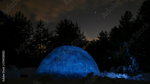 Igloo at night scene. Winter landscape glowing by star light