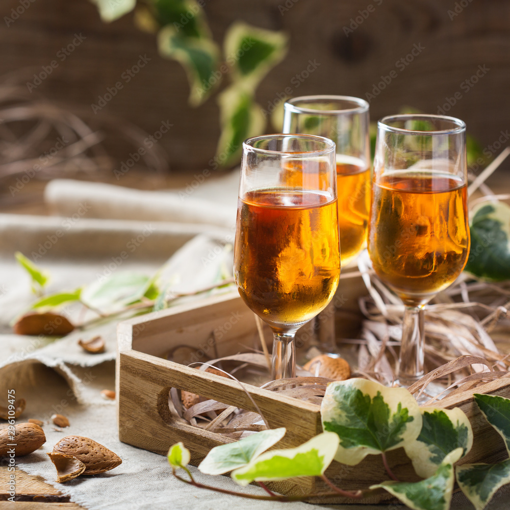 Italian almond liquor amaretto on a wooden table Italian almond liquor amaretto on a wooden table