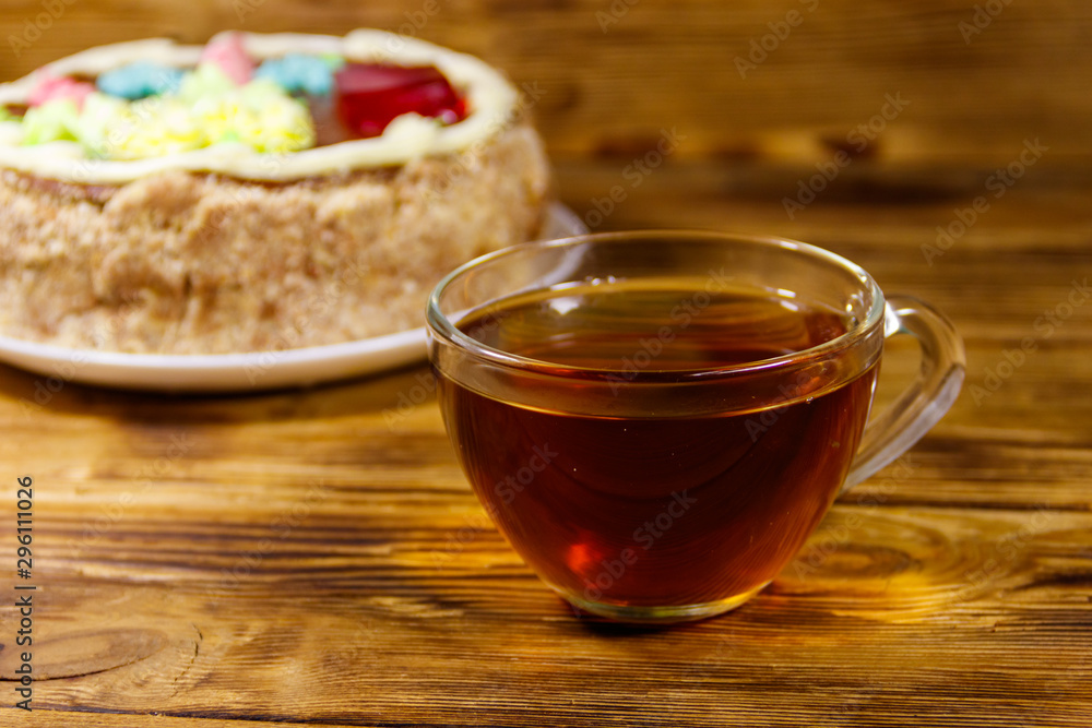Cup of tea and Kiev cake on a wooden table Cup of tea and Kiev cake on a wooden table