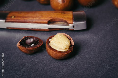 Fototapeta Naklejka Na Ścianę i Meble -  Several macadamia nuts on a black background