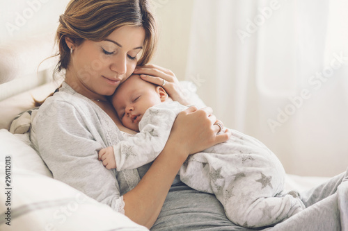 Loving mom carying of her newborn baby at home photo