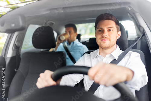 transport, vehicle and people concept - male driver driving car with passenger