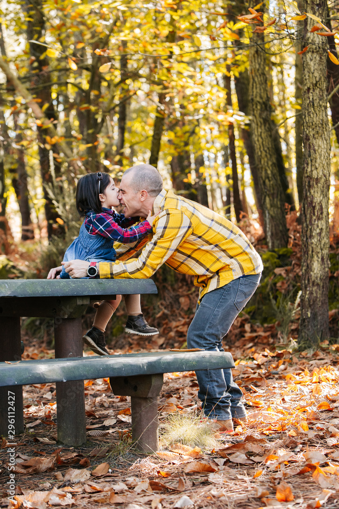 Father with daughter at park in autumn Father with daughter at park in autumn