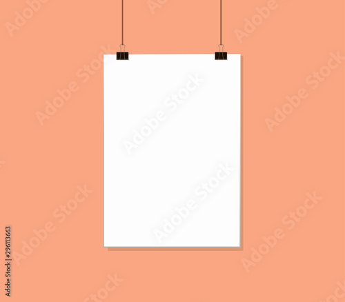 White poster mock up hanging on rope with paper clips near Pink peach color wall. Blank Canvas Mockup design template.